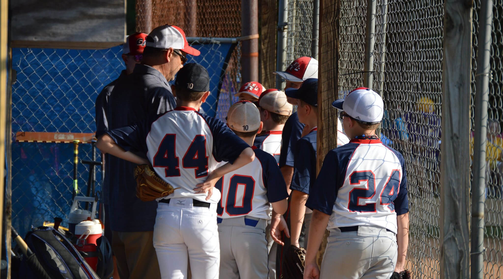 Georgia Academy Baseball players and coach in the dugout